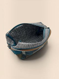 Blue and Earth Tone Patchwork Holland pouch, open and showing the grey interior lining — handmade by The Cozy Daisy