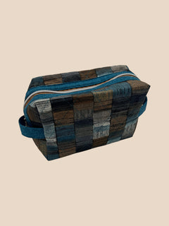 Blue and Earth Tone Patchwork Holland pouch, front three-quarter view, zipped closed — handmade by The Cozy Daisy
