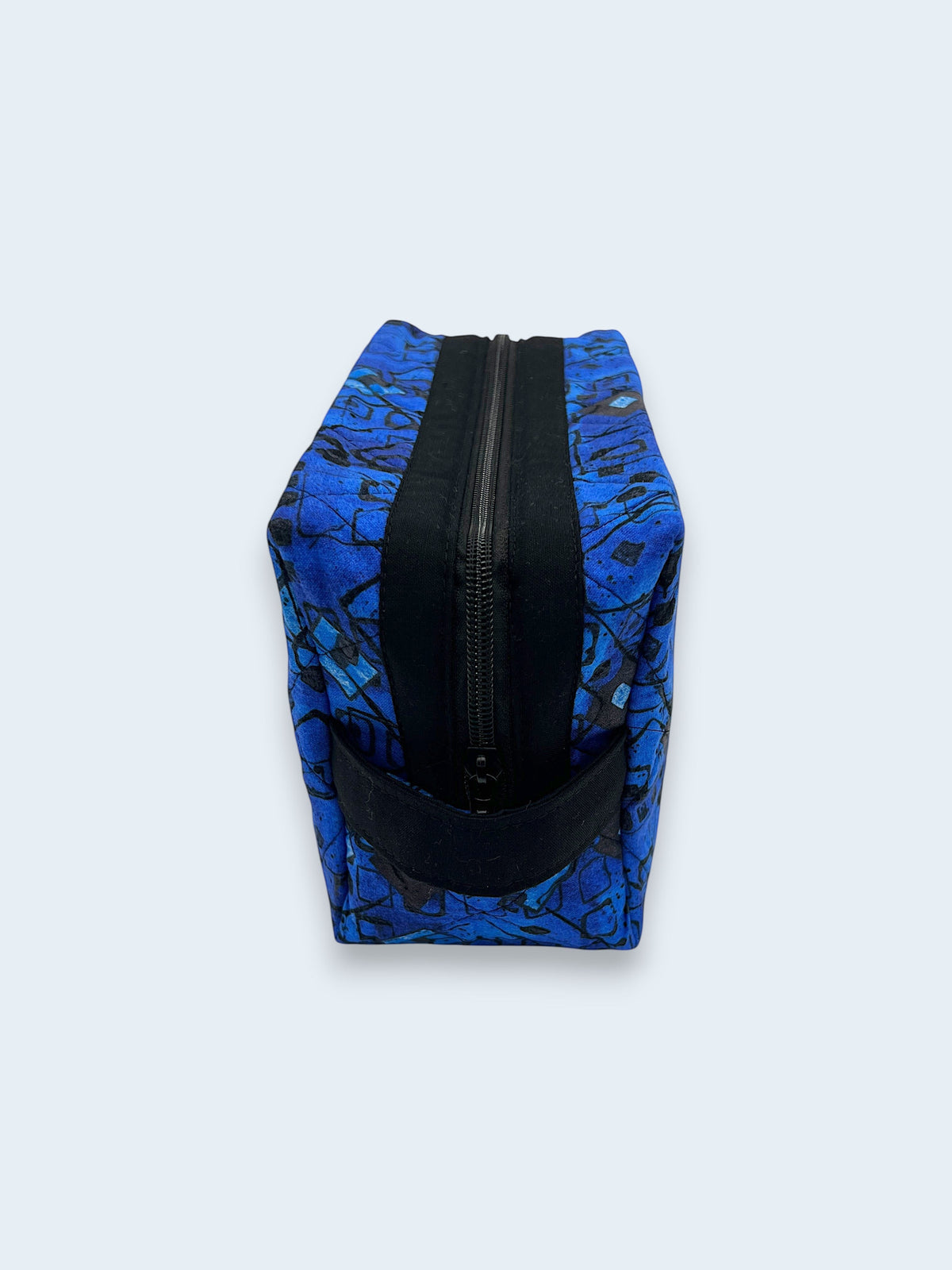 Blue Geometric Holland pouch, end view showing the boxy shape and black carry handle — handmade by The Cozy Daisy