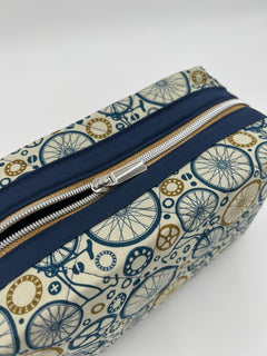 Wheels Go Round Holland pouch, top-down close-up of the bicycle-wheel print and zipper — handmade by The Cozy Daisy
