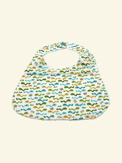 The Cozy Daisy baby bib in a white cotton fabric featuring a colorful worms print with a snap closure.