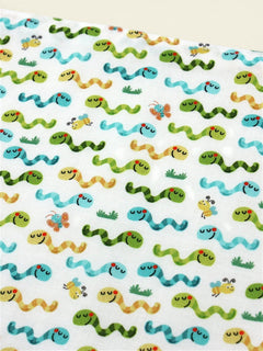 The Cozy Daisy baby bib featuring a playful worms and insects print on soft white cotton fabric.